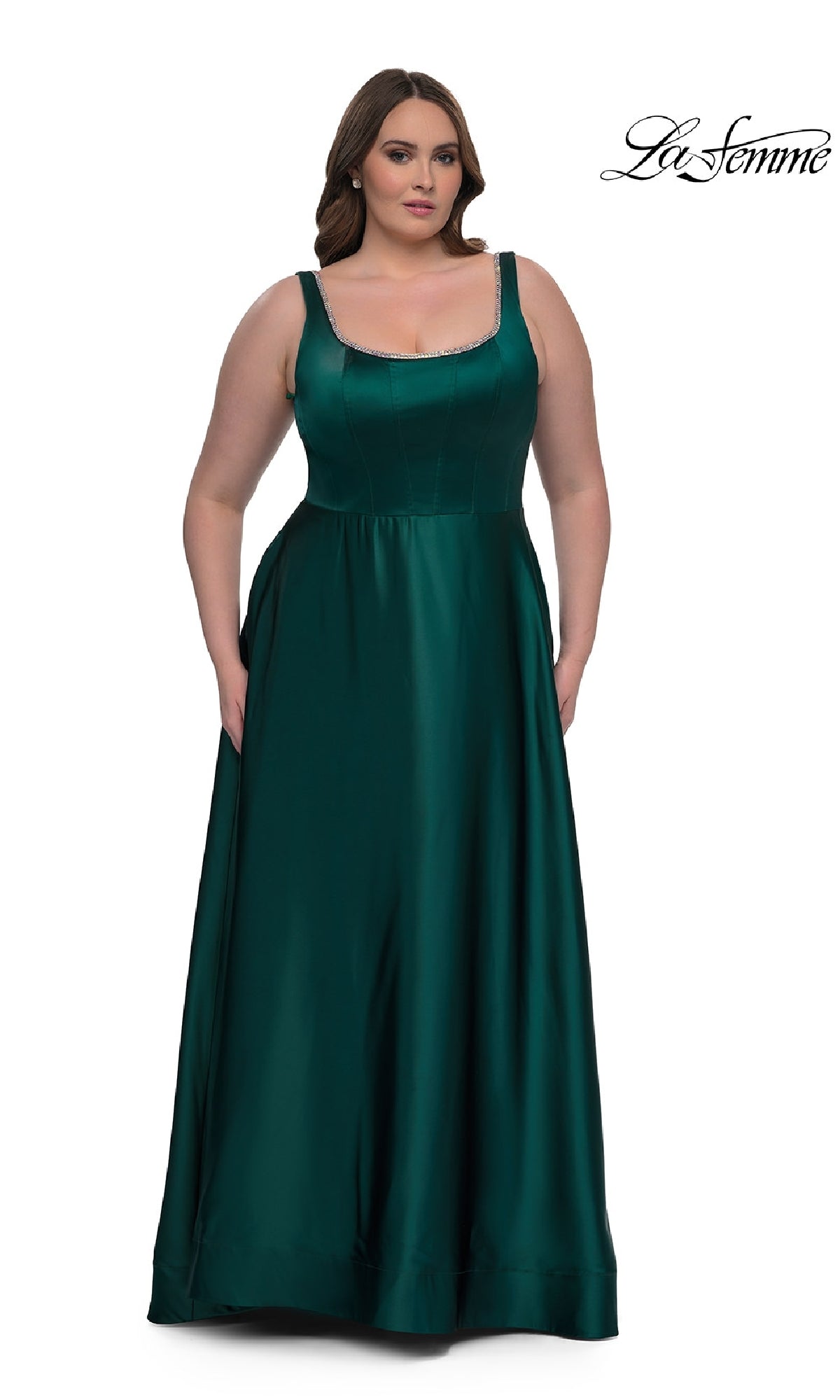 A woman models the Plus-Size Classic Long Prom Gown (La Femme 33026), a sleeveless, floor-length emerald green satin dress, against a white background with the